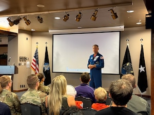 Astronaut stands in front of a group of people during a Q&A session.