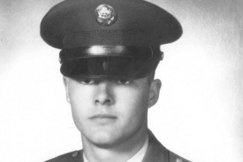A man wearing a military uniform poses for a photo.