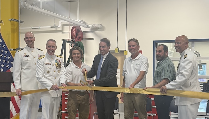LEFT: New family housing units at Base Kodiak, Alaska. RIGHT: Troy Edgar, deputy secretary of the Department of Homeland Security, ceremonially marks the opening of a new maintenance and weapons detachment building at Coast Guard Base Kodiak on Aug. 11, 2025. From left: Capt. Jeremy Hall, Base Kodiak commanding officer; Adm. Kevin Lunday, acting commandant of the Coast Guard; Noah Bauer, Perini Management Services; Edgar; Wayne Johnson, Perini Management Services; Stephen Santilli, Perini Management Services; and Capt. Neal Armstrong of the Coast Guard Facilities Design and Construction Center. U.S. Coast Guard photos.