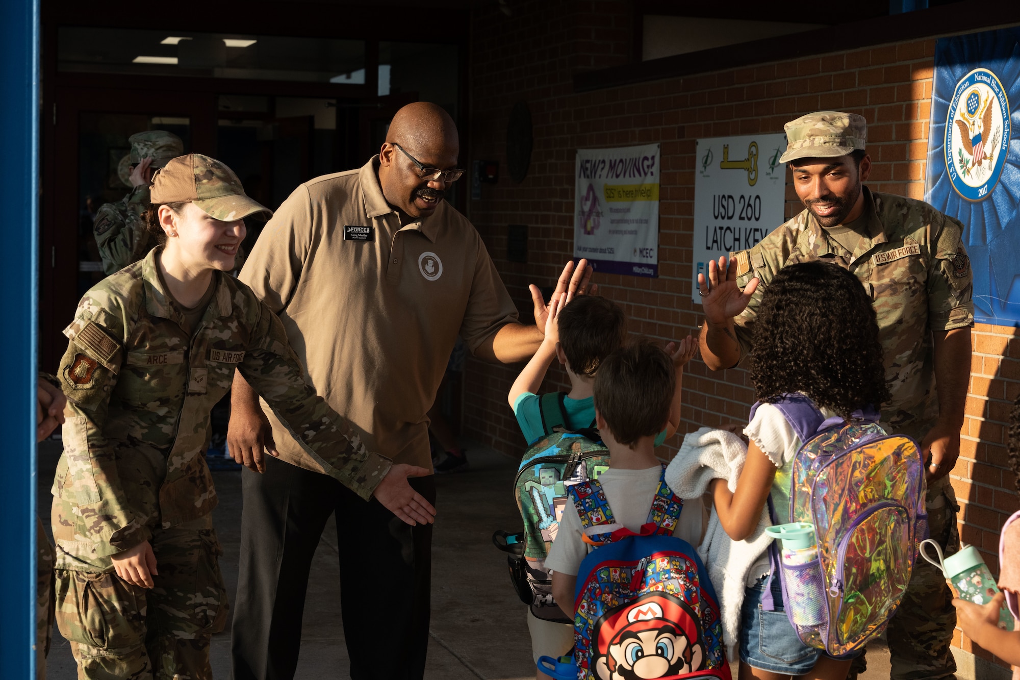 Members from Team McConnell greet students at Wineteer Elementary, Wichita, Kansas, Aug. 13, 2025. The high fives and handshakes program is a volunteer-based program that allows Airmen to go to local schools to greet students as they start their day. (U.S. Air Force photo by Senior Airman Felicia Przydzial)