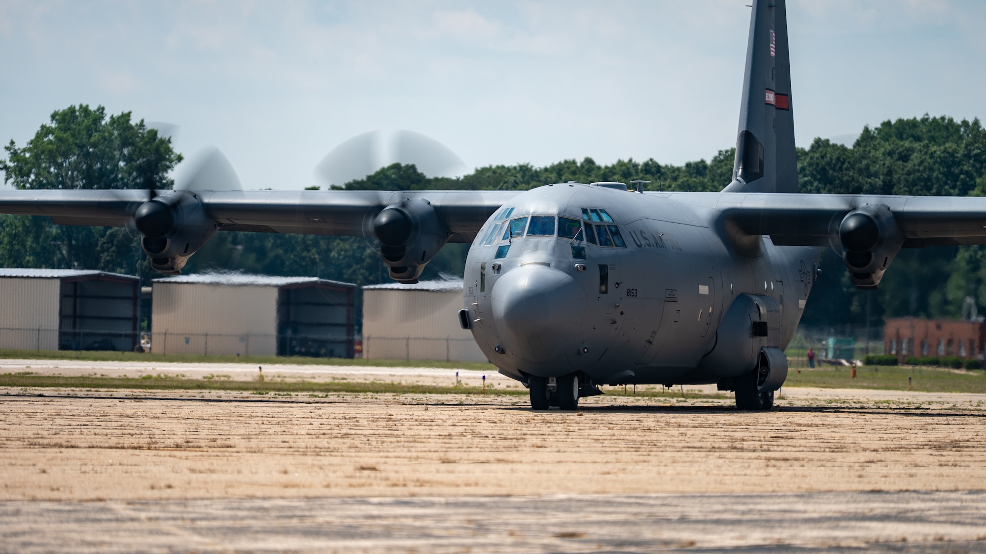 C-130J getting ready for take off on a runway.