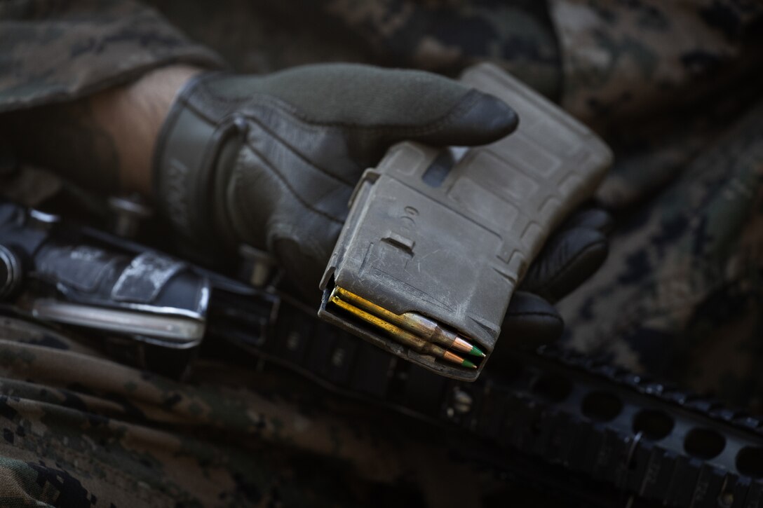 U.S. Marine Corps Lance Cpl. Angel Rodas, a machine gunner with 2nd Battalion, 23rd Marines, forward deployed with 4th Marine Regiment, 3d Marine Division as part of the Unit Deployment Program, prepares to load a magazine before zeroing his M4 carbine rifle on a battle sight zero range during the Korean Marine Exercise Program 25.2 in Pocheon, South Korea, July 26, 2025. KMEP is conducted regularly between the ROK and U.S. Marine Corps to increase their combined capabilities through realistic training geared towards deterrence and maintaining peace in the Indo-Pacific. (U.S. Marine Corps photo by Lance Cpl. Van Hoang)