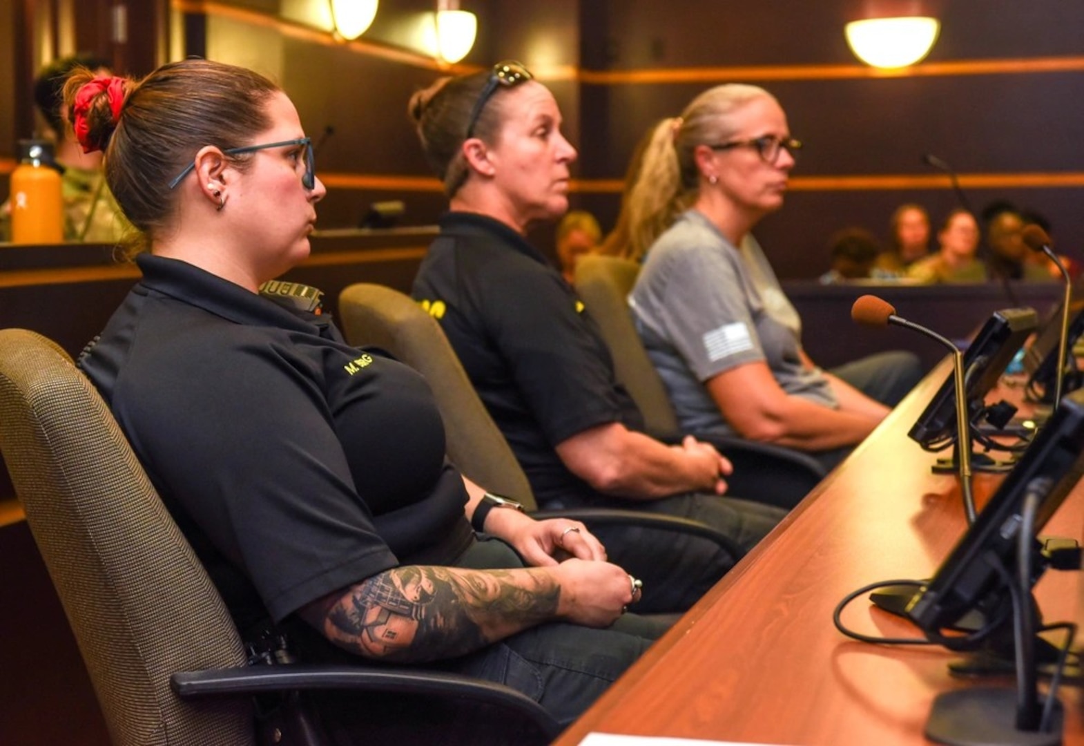Farrah McClain, a member of Womack's Sexual Assault Medical Forensic Examiners team, is flanked by two Fayetteville police officers during their mock trial in preparation for sexual assault cases.