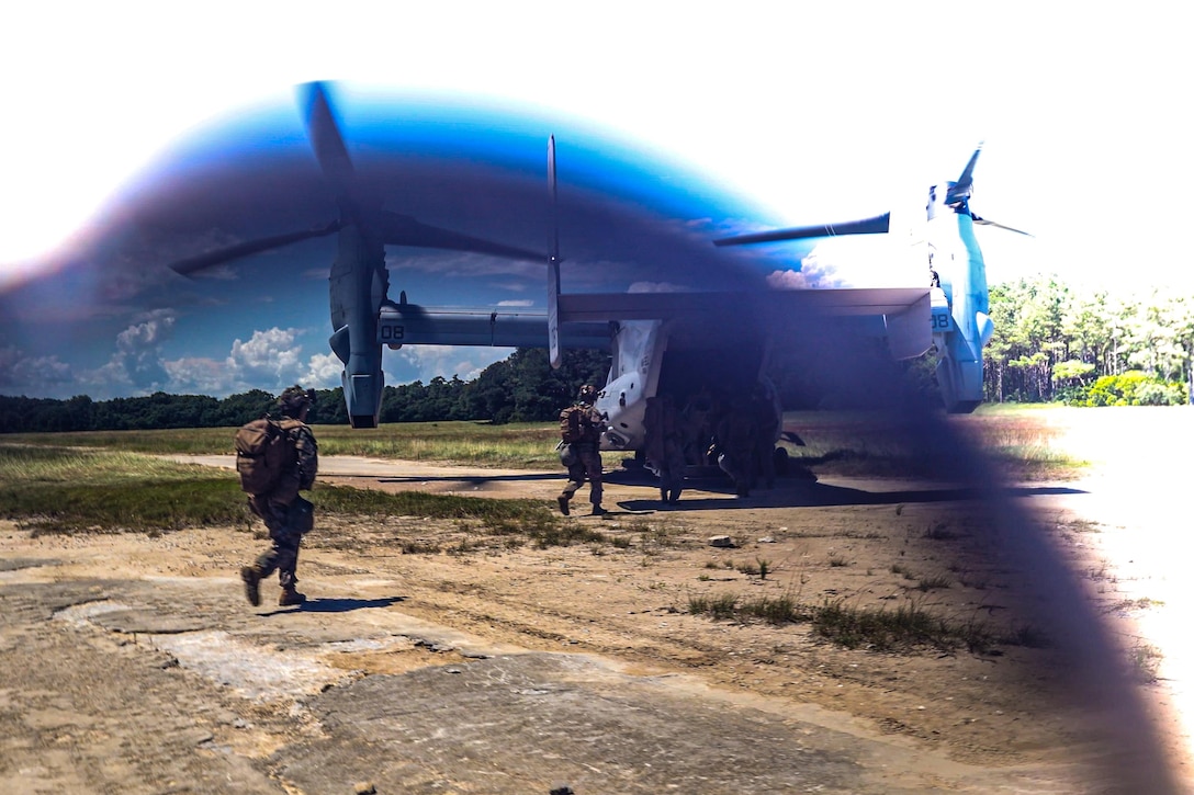 U.S. Marines with Weapons Company, Battalion Landing Team 3/6, 22nd Marine Expeditionary Unit (Special Operations Capable), load onto a CH-53 Super Stallion helicopter during a tactical recovery of aircraft and personnel mission from the U.S. Navy Wasp-class amphibious assault ship USS Iwo Jima (LHD 7), in support of Composite Training Unit Exercise while underway in the Atlantic Ocean, June 28, 2025. During COMPTUEX, the IWO ARG and 22nd MEU(SOC), refine tactics, techniques, and procedures to execute warfighting functions that enhance operational readiness and lethality as a unified IWOARG/22 MEU(SOC) team. (U.S. Marine Corps photo by Cpl. Emily Hazelbaker)