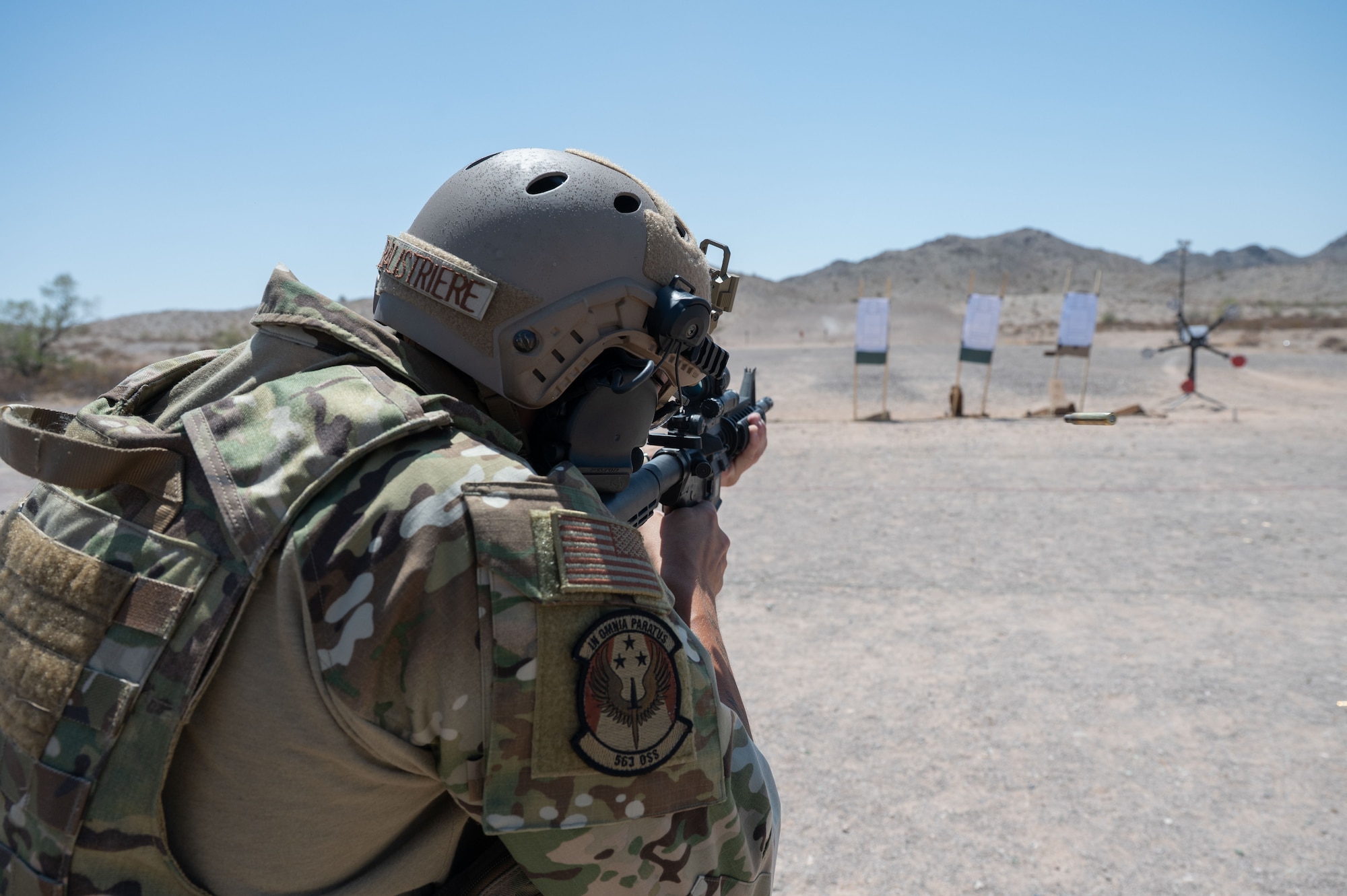 U.S. Air Force Staff Sgt. Austin Balistriere, 563rd Operations Support Squadron aerial delivery noncommissioned officer in charge, shoots at targets during the German Armed Forces Schützenschnur event at Gila Bend, Arizona, August 8, 2025. Airmen were tasked with shooting the targets in different positions while performing burpees in between. (U.S. Air Force photo by Airman Jaden Kidd)