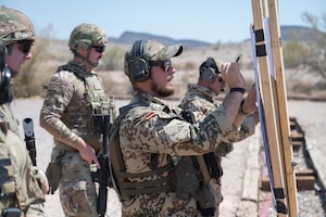 U.S. Air Force Airmen’s targets are graded by German Armed Forces service members during the German Armed Forces Schützenschnur event at Gila Bend, Arizona, August 8, 2025.  Airmen were awarded with German Armed Forces Badge for Weapons Proficiency in either bronze, silver or gold depending on their proficiency. (U.S. Air Force photo by Airman Jaden Kidd)