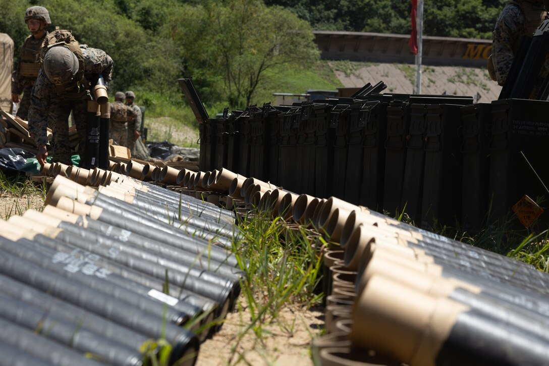 U.S. Marines with 2nd Battalion, 23rd Marines, forward deployed with 4th Marine Regiment, 3d Marine Division as part of the Unit Deployment Program, organize empty 81mm mortar round cases after firing during the Korean Marine Exercise Program 25.2 in Pocheon, South Korea, July 28, 2025. KMEP is conducted regularly between the ROK and U.S. Marine Corps to increase their combined capabilities through realistic training geared towards deterrence and maintaining peace in the Indo-Pacific. (U.S. Marine Corps photo by Lance Cpl. Van Hoang)