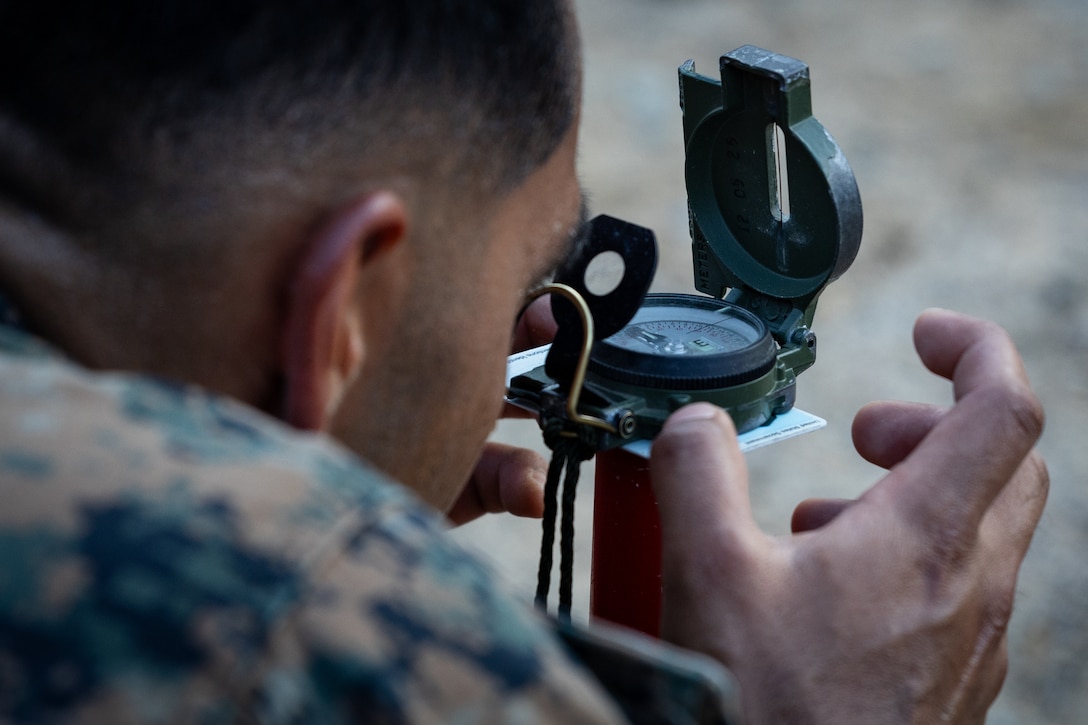 A U.S. Marines with 2nd Battalion, 23rd Marines, forward deployed with 4th Marine Regiment, 3d Marine Division as part of the Unit Deployment Program, sets up aiming stakes before firing 81mm mortars during the Korean Marine Exercise Program 25.2 in Pocheon, South Korea, July 28, 2025. KMEP is conducted regularly between the ROK and U.S. Marine Corps to increase their combined capabilities through realistic training geared towards deterrence and maintaining peace in the Indo-Pacific. (U.S. Marine Corps photo by Lance Cpl. Van Hoang)