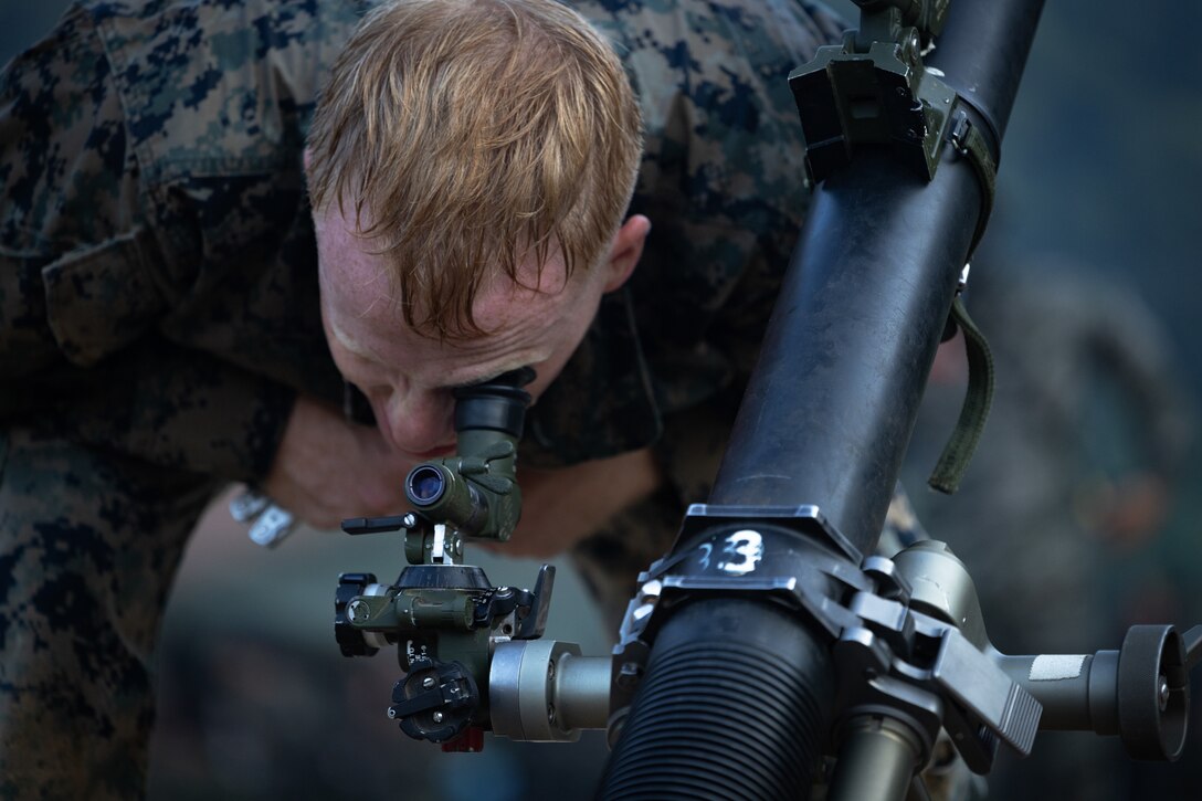 U.S. Marine Corps Cpl. Reece Frasier, a mortarman with 2nd Battalion, 23rd Marines, forward deployed with 4th Marine Regiment, 3d Marine Division as part of the Unit Deployment Program, looks through an M67A1 sight unit on an 81mm mortar during the Korean Marine Exercise Program 25.2 in Pocheon, South Korea, July 28, 2025. KMEP is conducted regularly between the ROK and U.S. Marine Corps to increase their combined capabilities through realistic training geared towards deterrence and maintaining peace in the Indo-Pacific. (U.S. Marine Corps photo by Lance Cpl. Van Hoang)