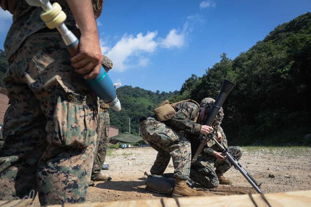 U.S. Marines with 2nd Battalion, 23rd Marines, forward deployed with 4th Marine Regiment, 3d Marine Division as part of the Unit Deployment Program, sight in on an M67A1 sight unit before firing 81mm mortar rounds during the Korean Marine Exercise Program 25.2 in Pocheon, South Korea, July 28, 2025. KMEP is conducted regularly between the ROK and U.S. Marine Corps to increase their combined capabilities through realistic training geared towards deterrence and maintaining peace in the Indo-Pacific. (U.S. Marine Corps photo by Lance Cpl. Van Hoang)