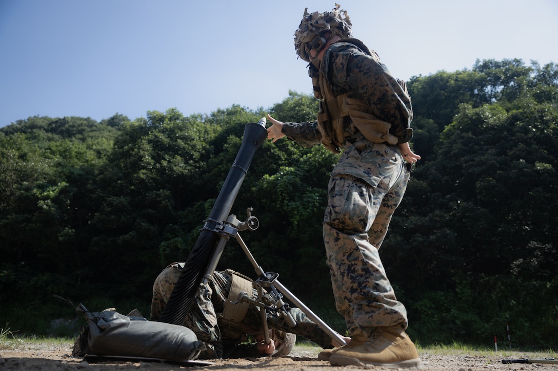 U.S. Marine Corps Cpl. Reece Frasier, a mortarman with 2nd Battalion, 23rd Marines, forward deployed with 4th Marine Regiment, 3d Marine Division as part of the Unit Deployment Program, releases an 81mm mortar round during the Korean Marine Exercise Program 25.2 in Pocheon, South Korea, July 28, 2025. KMEP is conducted regularly between the ROK and U.S. Marine Corps to increase their combined capabilities through realistic training geared towards deterrence and maintaining peace in the Indo-Pacific. (U.S. Marine Corps photo by Lance Cpl. Van Hoang)