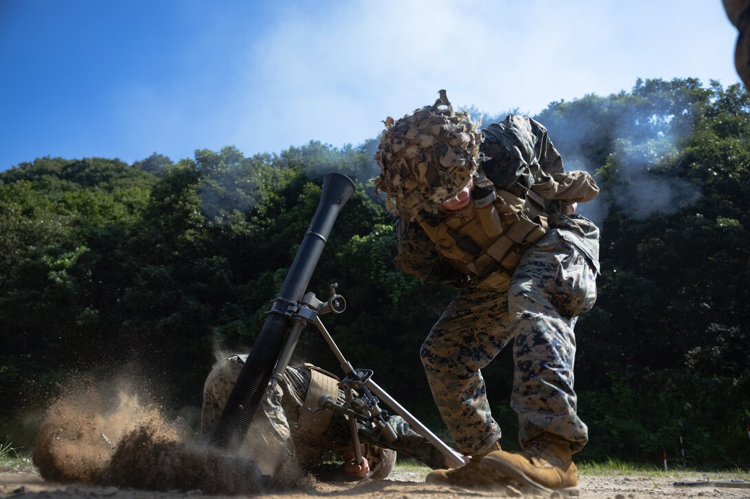 U.S. Marine Corps Cpl. Reece Frasier, a mortarman with 2nd Battalion, 23rd Marines, forward deployed with 4th Marine Regiment, 3d Marine Division as part of the Unit Deployment Program, fires an 81mm mortar round during the Korean Marine Exercise Program 25.2 in Pocheon, South Korea, July 28, 2025. KMEP is conducted regularly between the ROK and U.S. Marine Corps to increase their combined capabilities through realistic training geared towards deterrence and maintaining peace in the Indo-Pacific. (U.S. Marine Corps photo by Lance Cpl. Van Hoang)