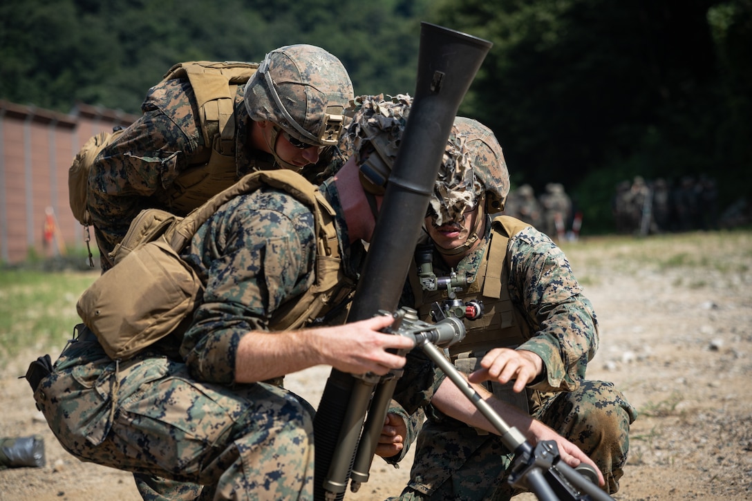 U.S. Marines with 2nd Battalion, 23rd Marines, forward deployed with 4th Marine Regiment, 3d Marine Division as part of the Unit Deployment Program, adjust an 81mm mortar during the Korean Marine Exercise Program 25.2 in Pocheon, South Korea, July 28, 2025. KMEP is conducted regularly between the ROK and U.S. Marine Corps to increase their combined capabilities through realistic training geared towards deterrence and maintaining peace in the Indo-Pacific. (U.S. Marine Corps photo by Lance Cpl. Van Hoang)