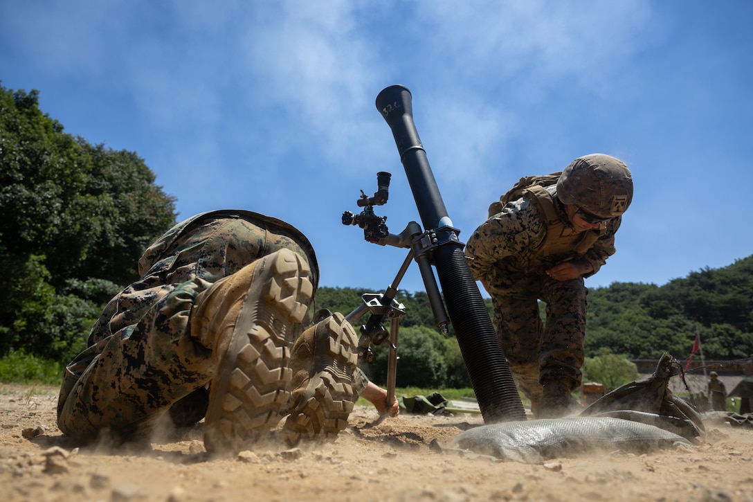 U.S. Marines with 2nd Battalion, 23rd Marines, forward deployed with 4th Marine Regiment, 3d Marine Division as part of the Unit Deployment Program, conduct a fire mission with an 81mm mortar during the Korean Marine Exercise Program 25.2 in Pocheon, South Korea, July 28, 2025. KMEP is conducted regularly between the ROK and U.S. Marine Corps to increase their combined capabilities through realistic training geared towards deterrence and maintaining peace in the Indo-Pacific. (U.S. Marine Corps photo by Lance Cpl. Van Hoang)