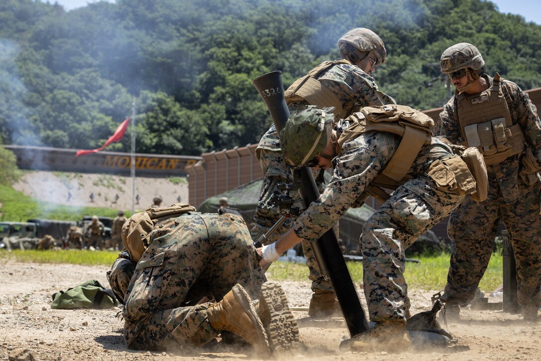 U.S. Marines with 2nd Battalion, 23rd Marines, forward deployed with 4th Marine Regiment, 3d Marine Division as part of the Unit Deployment Program, conduct a fire mission with an 81mm mortar during the Korean Marine Exercise Program 25.2 in Pocheon, South Korea, July 28, 2025. KMEP is conducted regularly between the ROK and U.S. Marine Corps to increase their combined capabilities through realistic training geared towards deterrence and maintaining peace in the Indo-Pacific. (U.S. Marine Corps photo by Lance Cpl. Van Hoang)