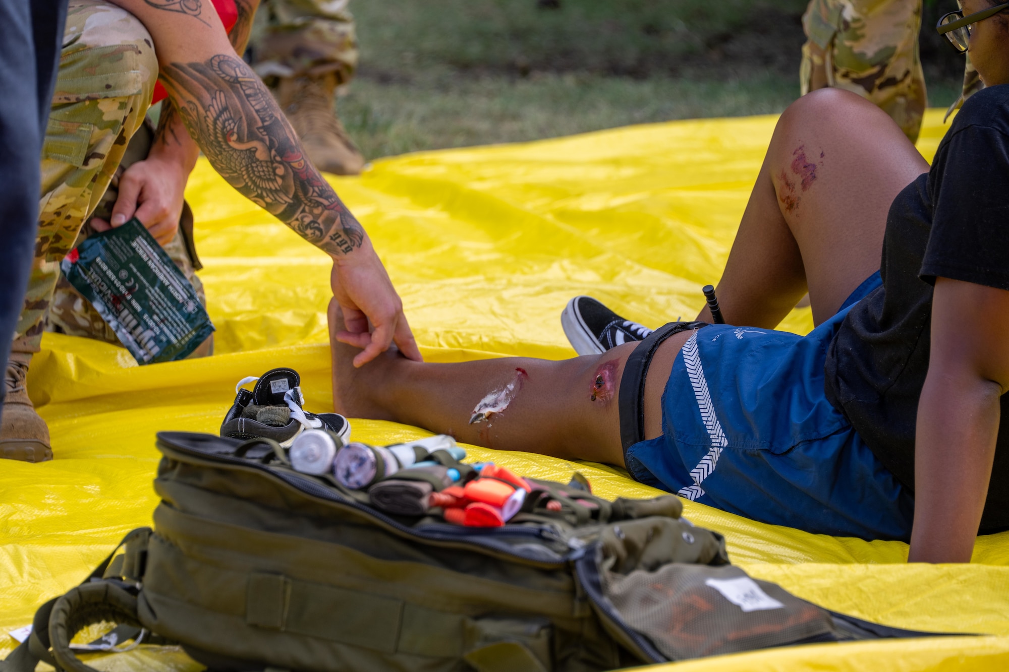 Airmen assigned to the 97th Air Mobility Wing tend to simulated injuries during an active shooter exercise at L. Mendel Rivers Elementary School at Altus Air Force Base, Oklahoma, Aug. 12, 2025. The training reinforced their ability to provide life-saving care under high-stress conditions, emphasizing the critical role of immediate medical attention. (U.S. Air Force photo by Airman 1st Class Lauren Torres)