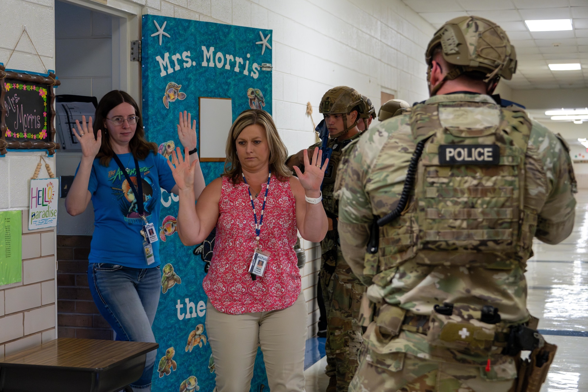 Airmen assigned to the 97th Security Forces Squadron clear a classroom with teachers inside during an active shooter exercise at L. Mendel Rivers Elementary School at Altus Air Force Base, Oklahoma, Aug. 12, 2025. The scenario tested their ability to identify and protect non-combatants while neutralizing potential threats quickly. (U.S. Air Force photo by Airman 1st Class Lauren Torres)