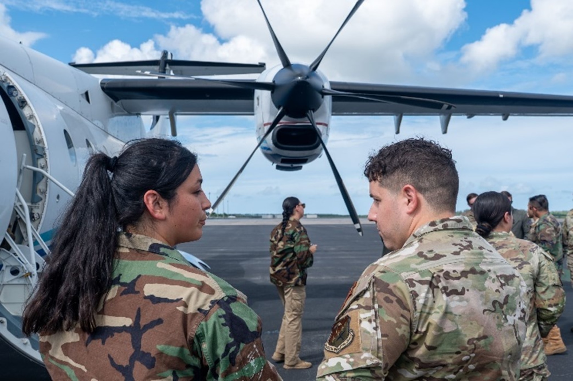 A 492nd Special Operations Wing Special Operations Advisor Team member, right, speaks with a role player, left, about the capabilities of a C-146 Wolfhound
