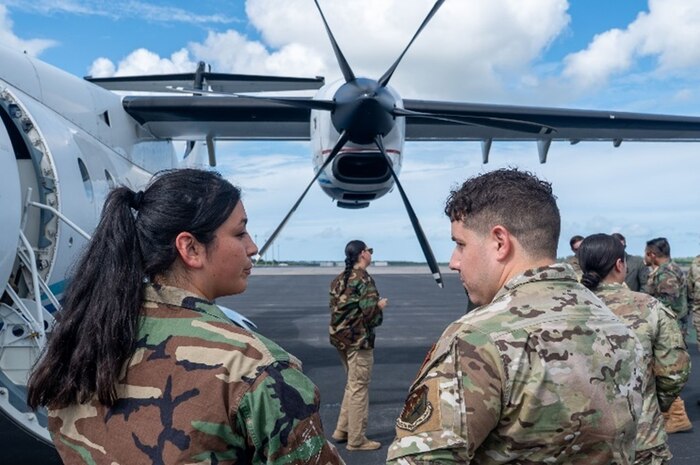 A 492nd Special Operations Wing Special Operations Advisor Team member, right, speaks with a role player, left, about the capabilities of a C-146 Wolfhound