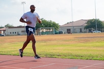 Airman runs on track outside.