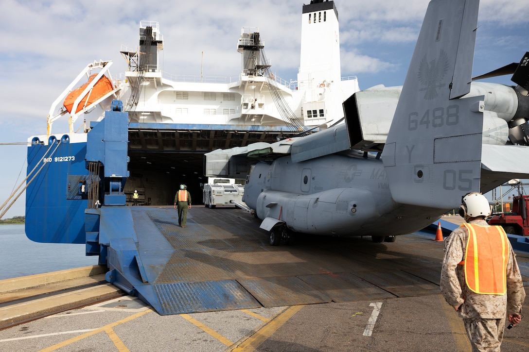 U.S. Marines pull an MV-22 Osprey aboard a contracted vessel Aug. 15, 2025, at Dames Point Marine Terminal in Jacksonville, Florida. Blount Island Command provided tow tractors and other prepositioned equipment to support Marine Medium Tiltrotor Squadron 162 (Reinforced) as part of regional responsiveness efforts in the U.S. Marine Corps Forces Europe and Africa area of responsibility. (Official Marine Corps Photo/Dustin Senger)