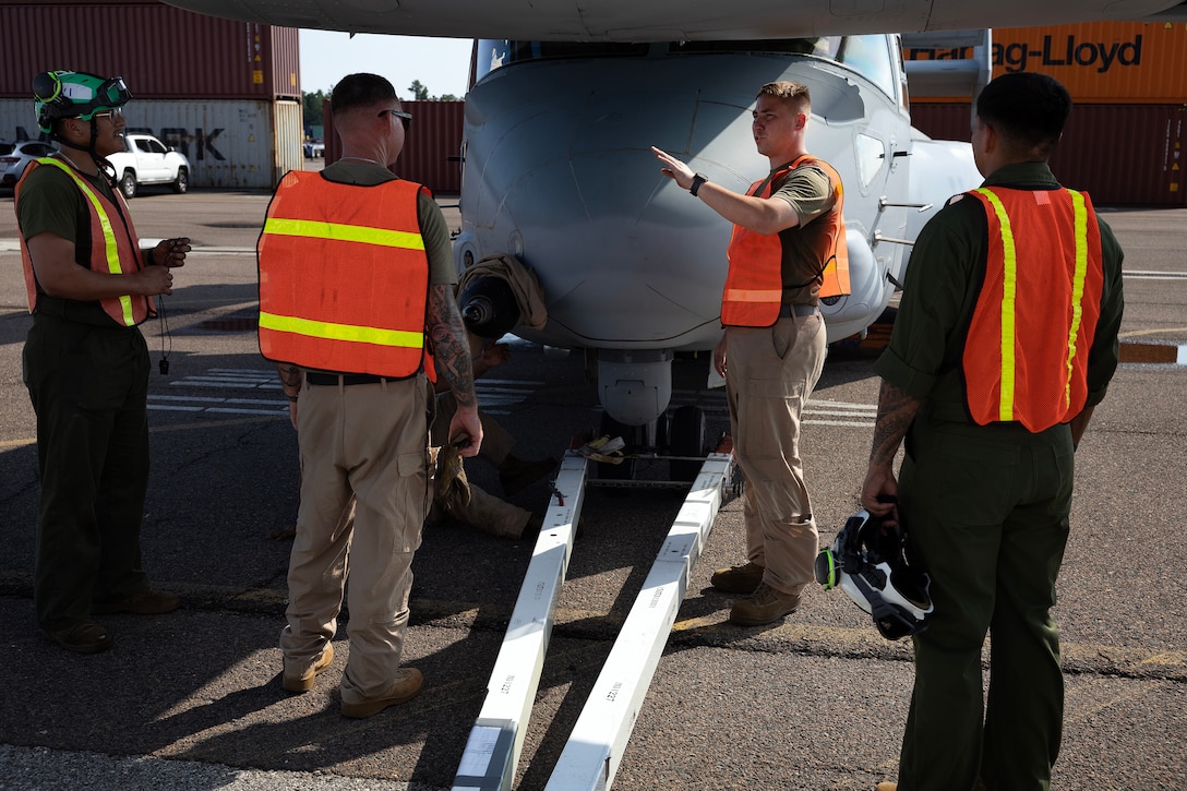 U.S. Marines prepare to pull an MV-22 Osprey aboard a contracted vessel Aug. 15, 2025, at Dames Point Marine Terminal in Jacksonville, Florida. Blount Island Command provided tow tractors and other prepositioned equipment to support Marine Medium Tiltrotor Squadron 162 (Reinforced) as part of regional responsiveness efforts in the U.S. Marine Corps Forces Europe and Africa area of responsibility. (Official Marine Corps Photo/Dustin Senger)