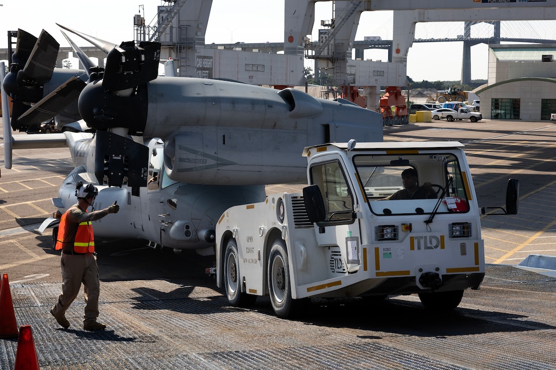 U.S. Marines pull an MV-22 Osprey aboard a contracted vessel Aug. 15, 2025, at Dames Point Marine Terminal in Jacksonville, Florida. Blount Island Command provided tow tractors and other prepositioned equipment to support Marine Medium Tiltrotor Squadron 162 (Reinforced) as part of regional responsiveness efforts in the U.S. Marine Corps Forces Europe and Africa area of responsibility. (Official Marine Corps Photo/Dustin Senger)