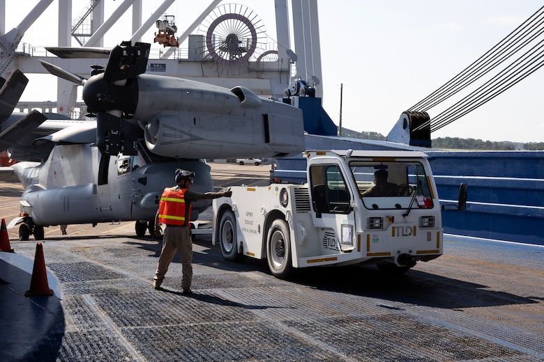 U.S. Marines load an MV-22 Osprey onto a vessel