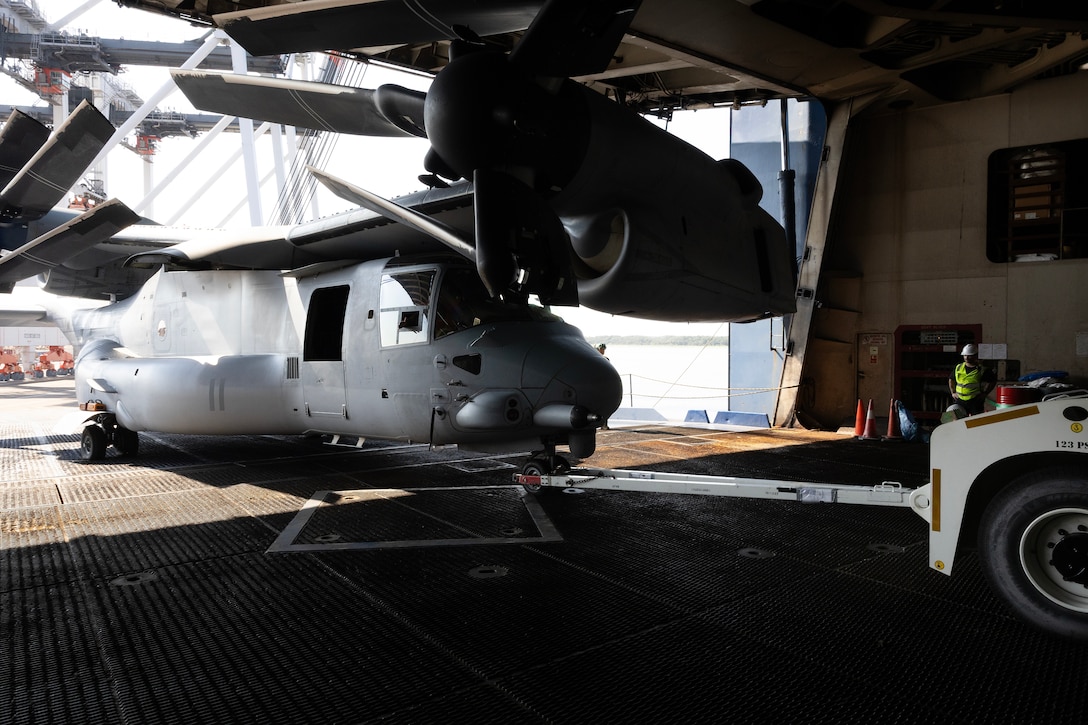 U.S. Marines pull an MV-22 Osprey aboard a contracted vessel Aug. 15, 2025, at Dames Point Marine Terminal in Jacksonville, Florida. Blount Island Command provided tow tractors and other prepositioned equipment to support Marine Medium Tiltrotor Squadron 162 (Reinforced) as part of regional responsiveness efforts in the U.S. Marine Corps Forces Europe and Africa area of responsibility. (Official Marine Corps Photo/Dustin Senger)