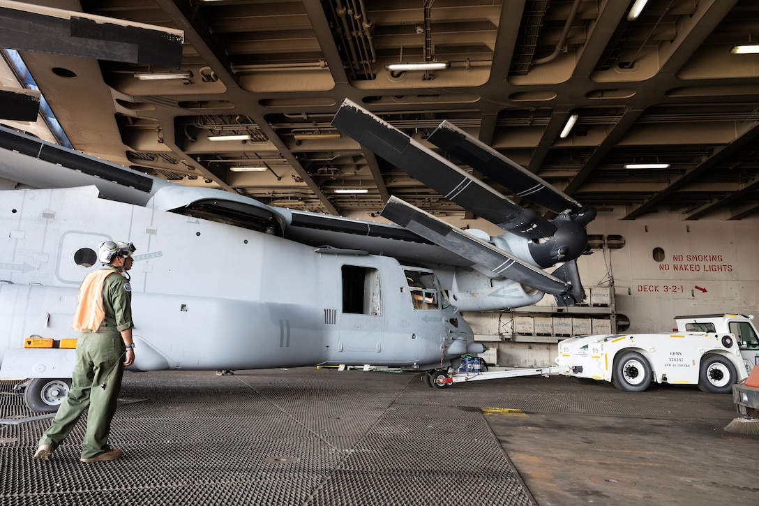 U.S. Marines pull an MV-22 Osprey aboard a contracted vessel Aug. 15, 2025, at Dames Point Marine Terminal in Jacksonville, Florida. Blount Island Command provided tow tractors and other prepositioned equipment to support Marine Medium Tiltrotor Squadron 162 (Reinforced) as part of regional responsiveness efforts in the U.S. Marine Corps Forces Europe and Africa area of responsibility. (Official Marine Corps Photo/Dustin Senger)