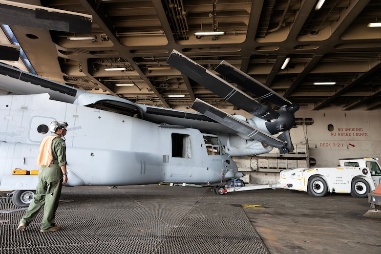 U.S. Marines load an MV-22 Osprey onto a vessel
