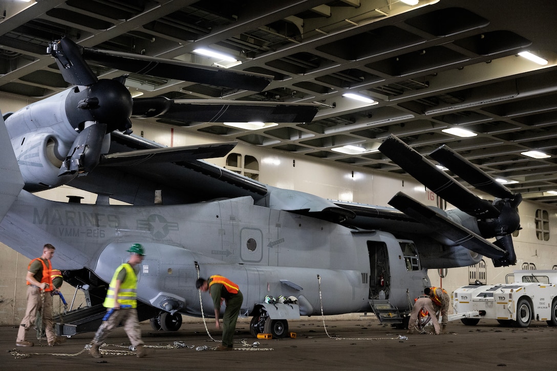 U.S. Marines secure an MV-22 Osprey aboard a contracted vessel Aug. 15, 2025, at Dames Point Marine Terminal in Jacksonville, Florida. Blount Island Command provided tow tractors and other prepositioned equipment to support Marine Medium Tiltrotor Squadron 162 (Reinforced) as part of regional responsiveness efforts in the U.S. Marine Corps Forces Europe and Africa area of responsibility. (Official Marine Corps Photo/Dustin Senger)