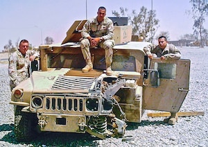 U.S. Air Force Chief Master Sgt. David A. Randolph, 30th Security Forces Squadron senior enlisted leader, then an Airman First Class, poses on a Humvee in July 2005 that was damaged by a landmine during a convoy to Mosul, Iraq, on June 22, 2005. Randolph and his team posed relative to the positions they were sitting in the Humvee during the attack. All three Airmen were awarded Purple Hearts for their injuries. While he physically recovered, Randolph endured years of suppressed emotional strain stemming from the incident. Randolph recently shared his story during a Hawk Talk event at Vandenberg Space Force Base, emphasizing the resilience of service members and the critical need for mental health support.