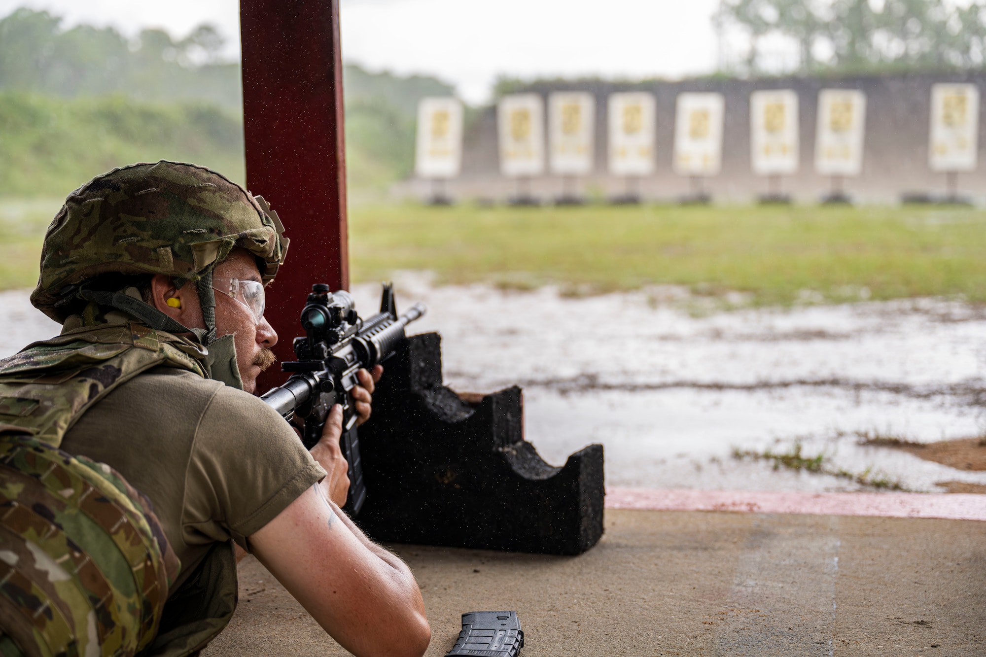An Airmen is pictured holding an M4 Carbine.