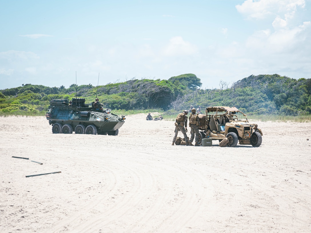A U.S. Marine Corps light armored vehicle with Battalion Landing Team 3/6, 22nd Marine Expeditionary Unit (Special Operations Capable), drives on a beach during an amphibious assault in support of Composite Training Unit Exercise on Marine Corps Base Camp Lejeune, July 9, 2025. During COMPTUEX, the Iwo Jima Amphibious Ready Group and 22nd MEU(SOC), refine tactics, techniques, and procedures to execute warfighting functions that enhance operational readiness and lethality as a unified IWOARG/22 MEU(SOC) team. (U.S. Marine Corps photo by Sgt. Tanner Bernat)