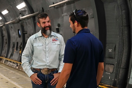 Chris Weaver, FBI San Antonio Citizens Academy participant, discusses the 433rd Airlift Wing mission and C-5M Super Galaxy capabilities with a member of the 433rd Airlift Wing Public Affairs team during a tour at Joint Base San Antonio-Lackland, Texas, Aug. 5, 2025.