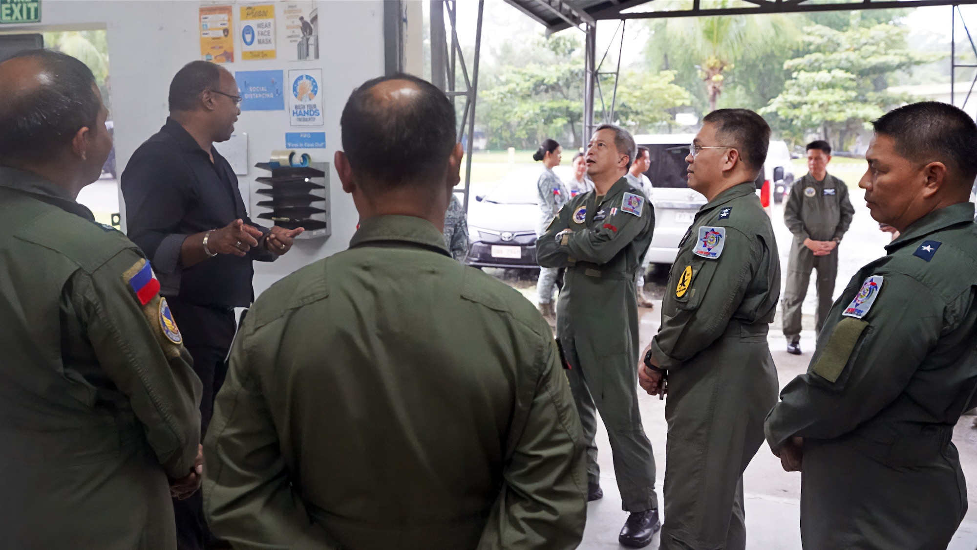 Ron Brown stands talking with Philippine military personnel.