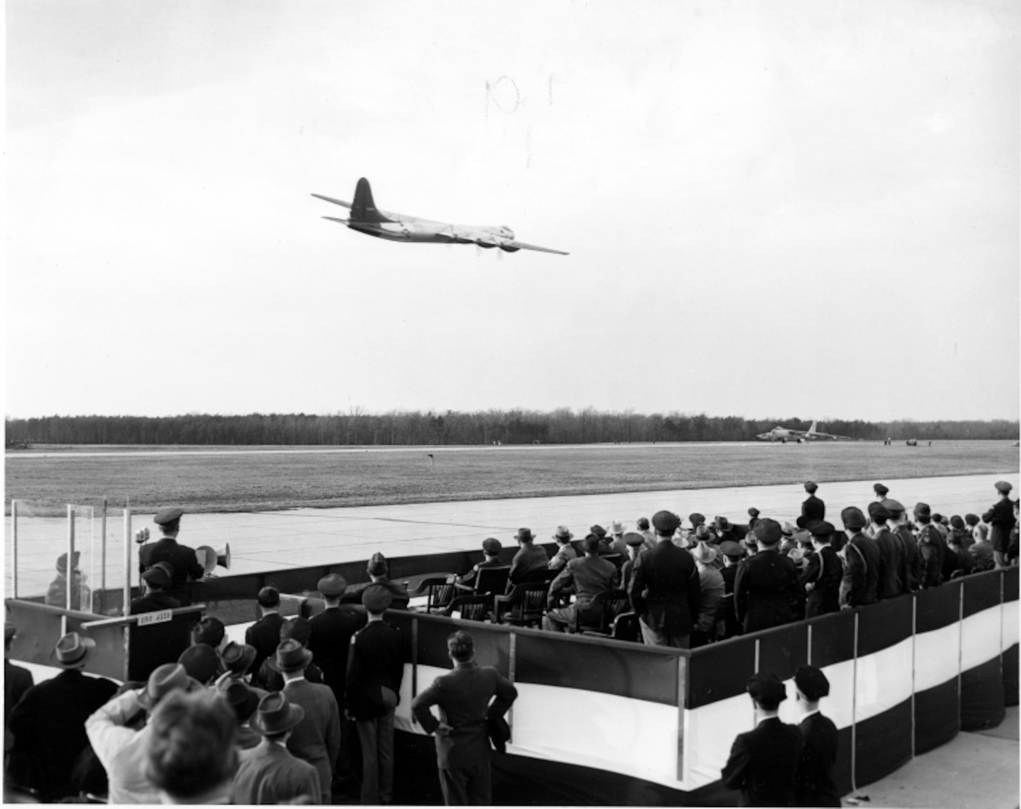 A crowd watches a military aircraft fly-over during an air show at Andrews Air Force Base, Maryland, February 15, 1949.