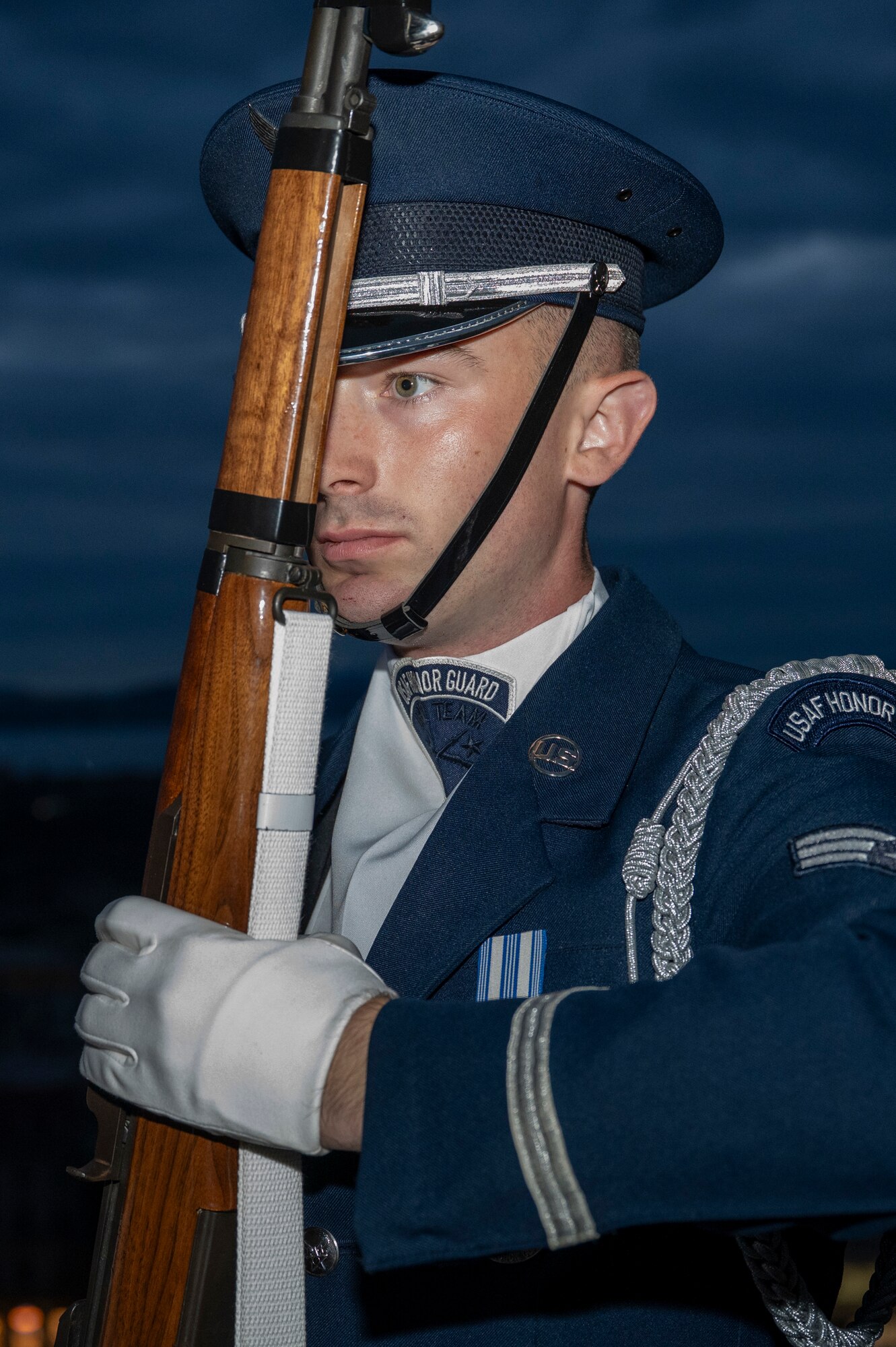 U.S. Air Force Senior Airman Crìsdean James Langan, ceremonial guardsman with the U.S. Air Force Honor Guard Drill Team, stands at port arms for a portrait at Edinburgh Castle during the 75th Royal Edinburgh Military Tattoo in Edinburgh, Scotland, Aug. 1, 2025. Langan watched the performance of the Drill team at the Royal Edinburgh Military Tattoo in 2022, which inspired him to enlist in the Air Force. (U.S. Air Force photo by Hayden Hallman)