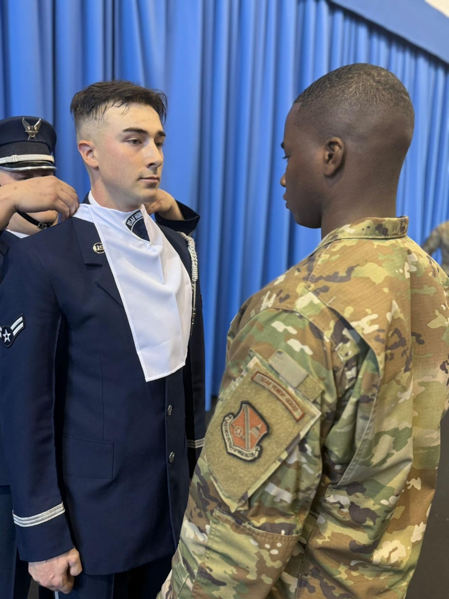 U.S. Air Force Airman 1st Class Crìsdean James Langan is presented with his ascot following graduation from the U.S. Air Force Honor Guard Drill Team Training at Joint Base Anacostia-Bolling, Washington, D.C., November 2024. Every member of the U.S. Air Force Honor Guard Drill Team receives an ascot with a blank patch upon graduation and has the opportunity to upgrade the patch during their time on the team. (Courtesy Photo)