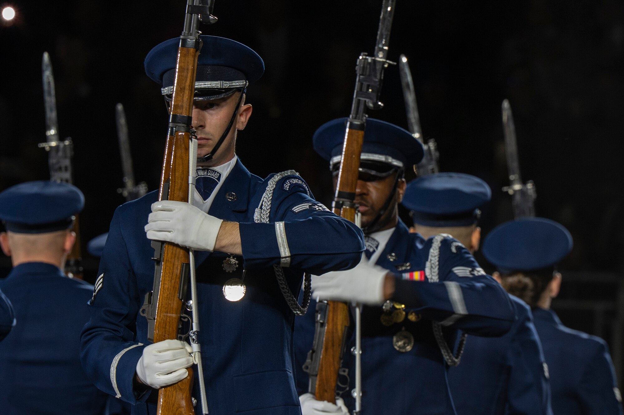 U.S. Air Force Senior Airman Crìsdean James Langan, front, ceremonial guardsman with the U.S. Air Force Honor Guard Drill Team, marches at port arms with members of the Drill Team during a performance in the 75th Royal Edinburgh Military Tattoo in Edinburgh, Scotland, Aug. 1, 2025. The tattoo brought hundreds of performers together for a cross-cultural exchange using music and military drill performances to foster partnerships. (U.S. Air Force photo by Hayden Hallman)