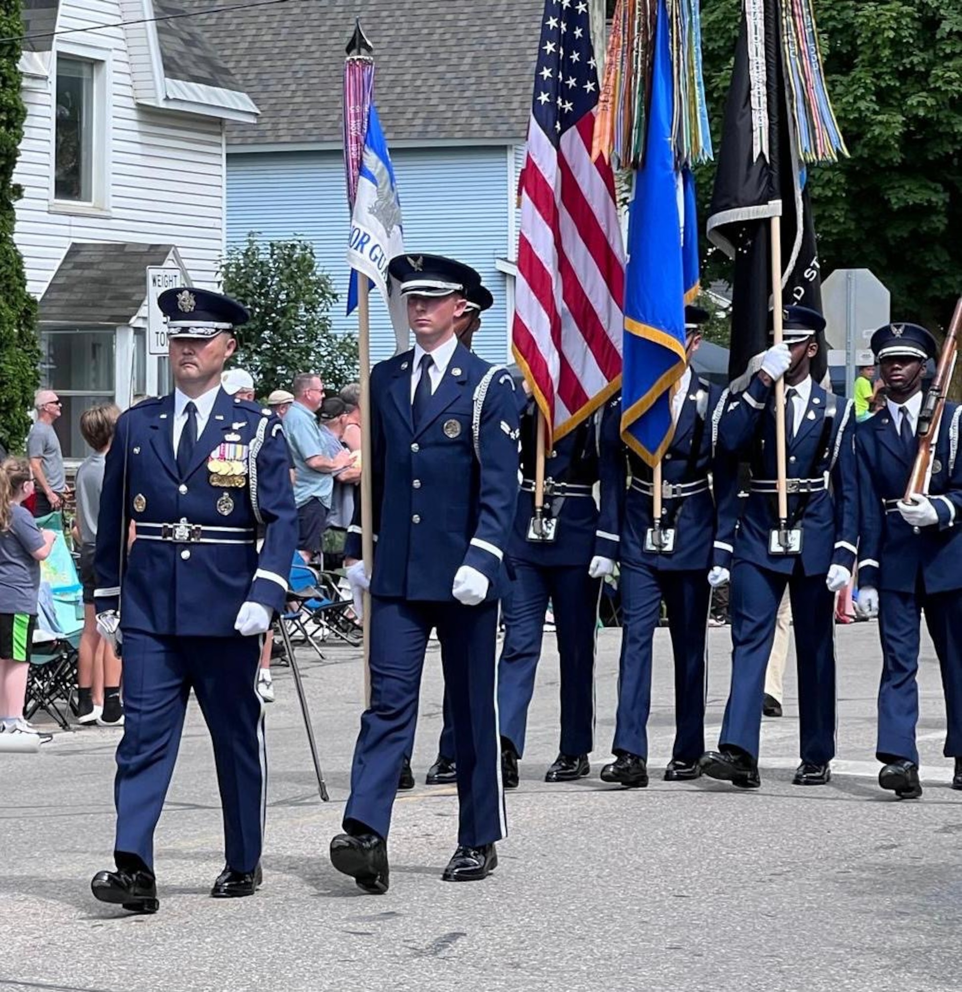 U.S. Air Force Airman 1st Class Crìsdean James Langan, center, ceremonial guardsmen with the U.S. Air Force Honor Guard, marches with the guidon during an Independence Day parade in Traverse City, Mich., July 4, 2024. Langan stated that he was proud to march at the front of the formation and considered it a privilege. (Courtesy Photo)