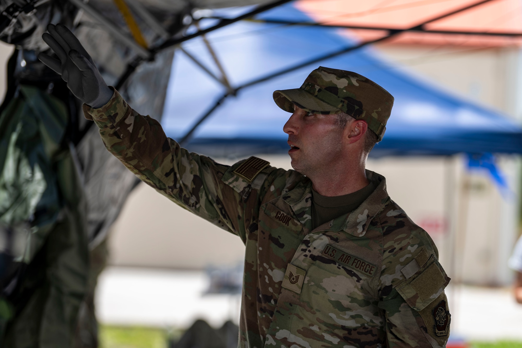 U.S. Air Force Tech. Sgt. Alexander Cook, 6th Air Refueling Wing public affairs craftsman, takes part in a tent building exercise at MacDill Air Force Base, Florida, July 31, 2025. The event preceded a tactical relay obstacle course, which tested Airmen’s ability to apply mission command principles in team-based tasks and  physically demanding scenarios. (U.S. Air Force photo by Airman 1st Class Monique Stober)
