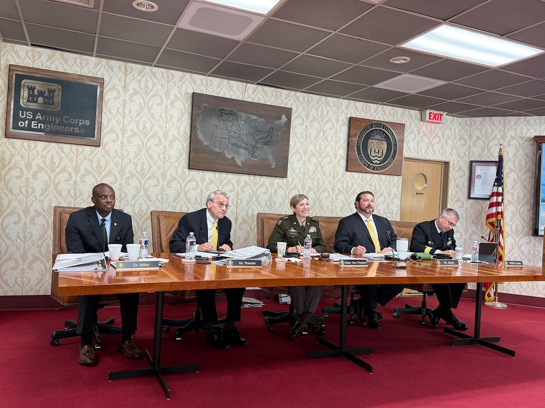 People sitting behind a hearing table