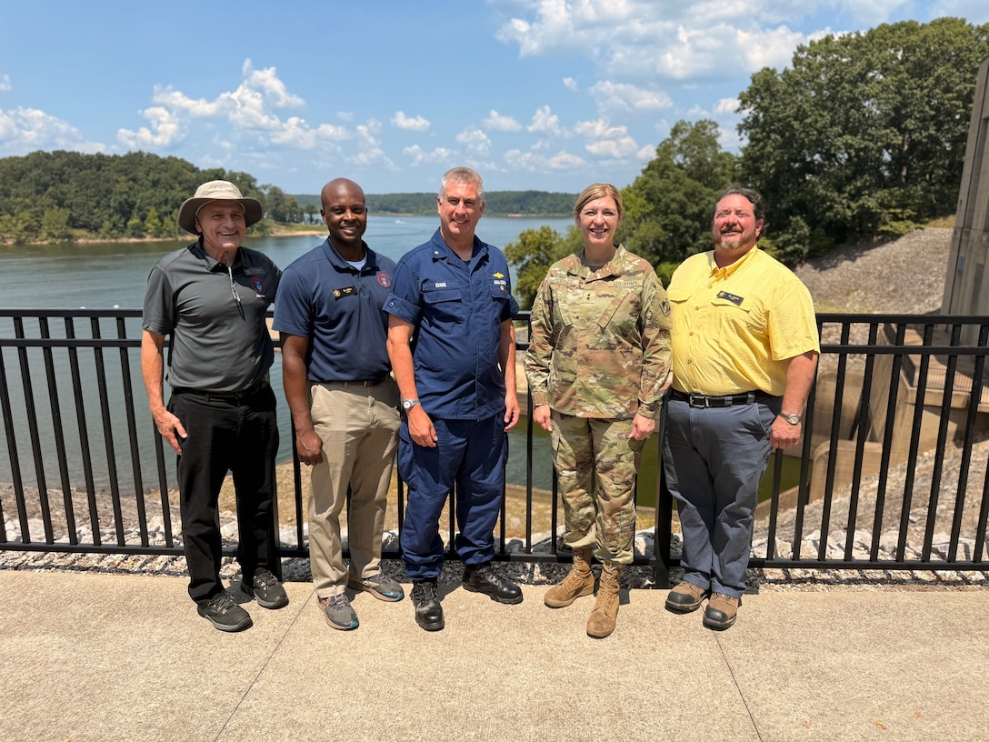 Group of people standing in front of lake