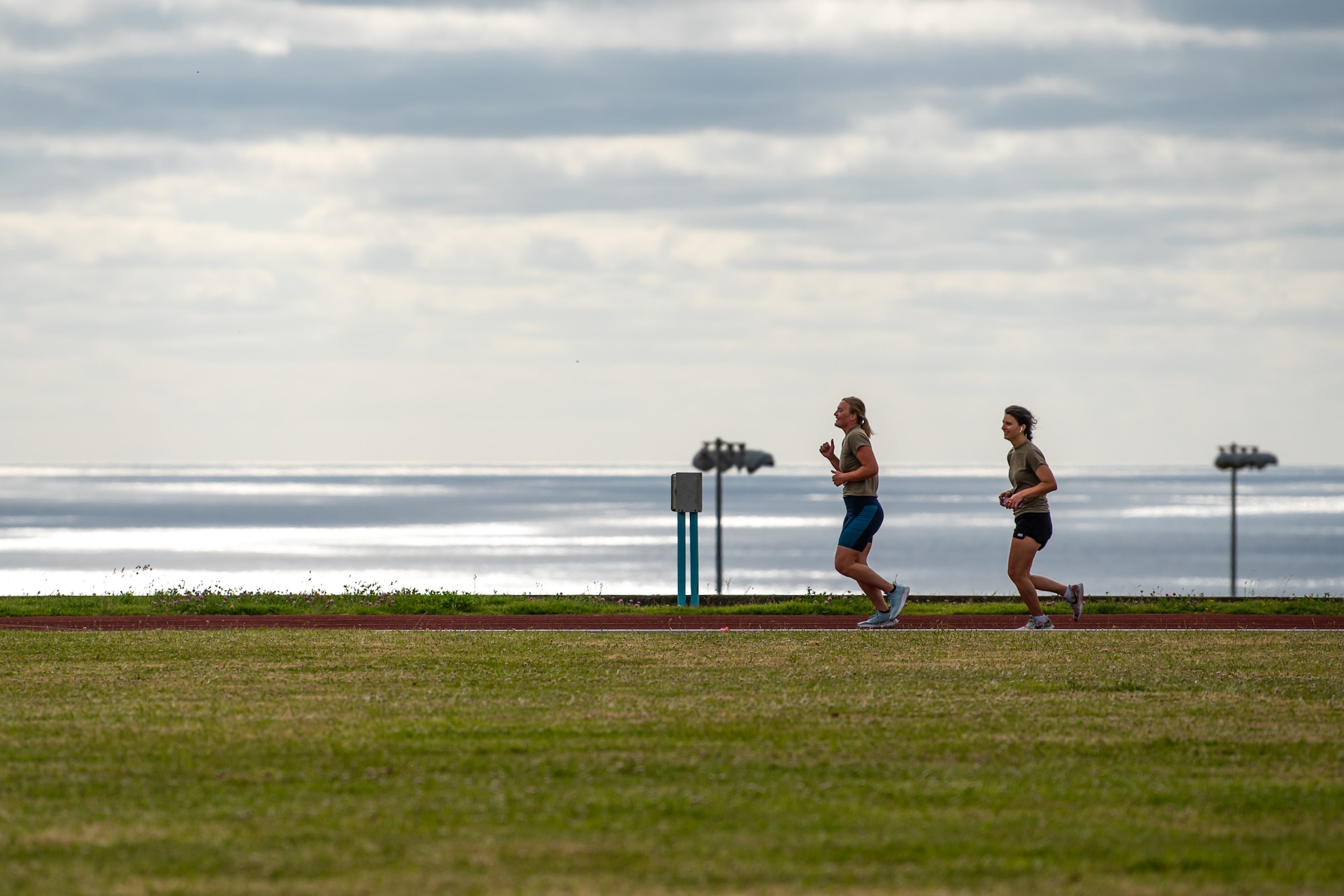 Capt. Jessica Cook, left, deputy operations flight commander for the Kentucky Air National Guard’s 123rd Civil Engineer Squadron, and Staff Sgt. Samantha Brown, the squadron’s unit training manager, complete a 5-mile run at Lajes Field, Azores, June 23, 2025, as part of a physical fitness event. The Airmen were at Lajes for a two-week field training deployment. (U.S. Air National Guard photo by Airman 1st Class Angelee Barnett)