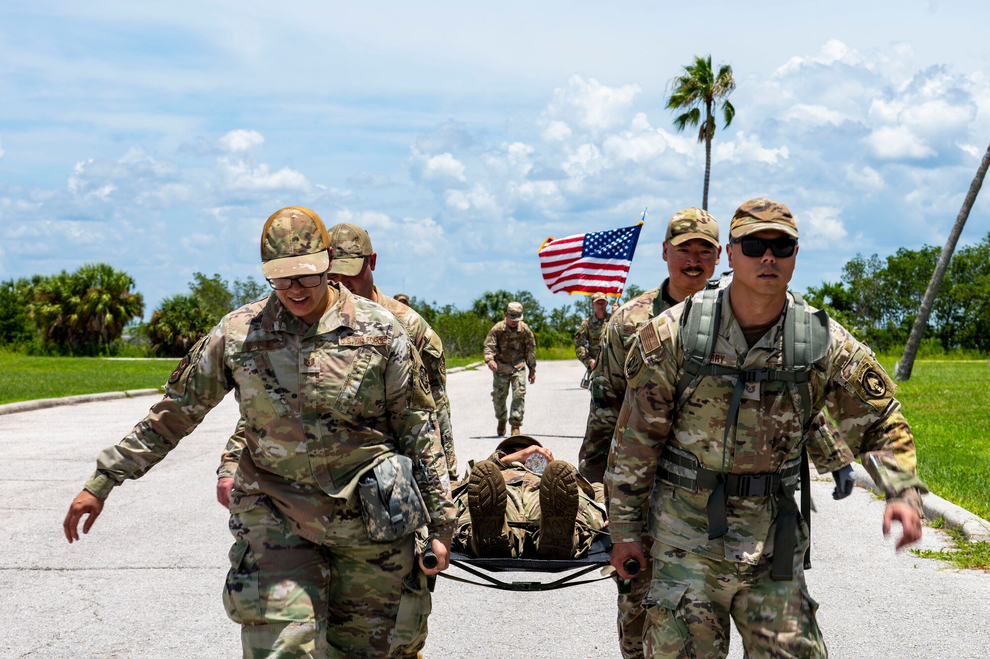 Senior noncommissioned officer selects carry a simulated casualty during a tactical relay as part of the Foundations 700 Course at MacDill Air Force Base, Florida, July 31, 2025. The week-long course focuses on leadership development, team cohesion, and warfighting competencies, preparing airmen for increased responsibilities in joint and operational environments. (U.S. Air Force photo by Airman 1st Class Monique Stober)
