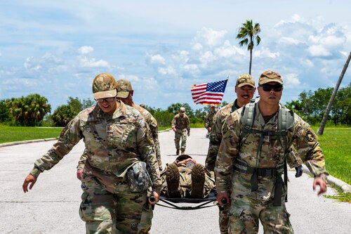 Senior noncommissioned officer selects carry a simulated casualty during a tactical relay as part of the Foundations 700 Course at MacDill Air Force Base, Florida, July 31, 2025. The week-long course focuses on leadership development, team cohesion, and warfighting competencies, preparing airmen for increased responsibilities in joint and operational environments. (U.S. Air Force photo by Airman 1st Class Monique Stober)
