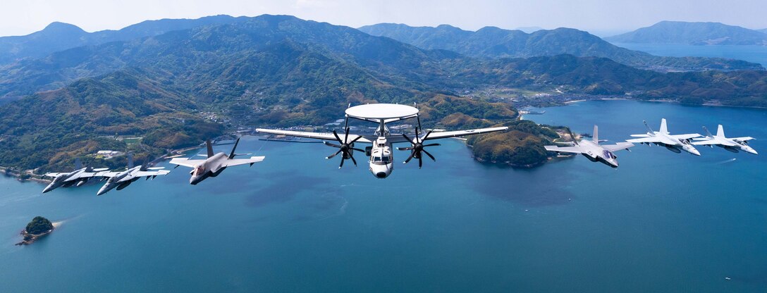 An E-2D Hawkeye, F-35C Lightning II, F/A-18F Super Hornet, F/A-18E Super Hornet and EA-18G Growler aircraft assigned to Carrier Air Wing (CVW) 5, fly in formation during Marine Corps Air Station Iwakuni’s 46th Friendship Day at MCAS Iwakuni, Japan, May 4, 2025. Since 1973, MCAS Iwakuni has held a Friendship Day open house to foster positive relationships between the air station and its Japanese hosts, offering a culturally enriching experience that displays the mutual support between the U.S. and Japan. CVW-5 is the U.S. Navy’s only permanently forward deployed air wing and consists of nine squadrons flying F-35C Lightning II, F/A-18E/F Super Hornets, EA-18G Growlers, E-2D Hawkeyes, CMV-22B Ospreys and MH-60R/S Sea Hawks used to conduct carrier air warfare operations and assist in the planning, control, coordination and integration of air wing squadrons in support of carrier air warfare. (U.S. Navy photo by Mass Communication Specialist 1st Class Ryre Arciaga)