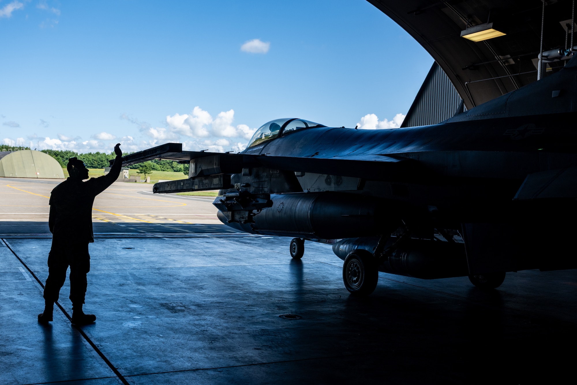 U.S. Air Force Staff Sgt. Pedro Muriel, 13th Fighter Generation Squadron crew chief, sends off an F-16 Fighting Falcon at Misawa Air Base, Japan, Aug. 13, 2025.